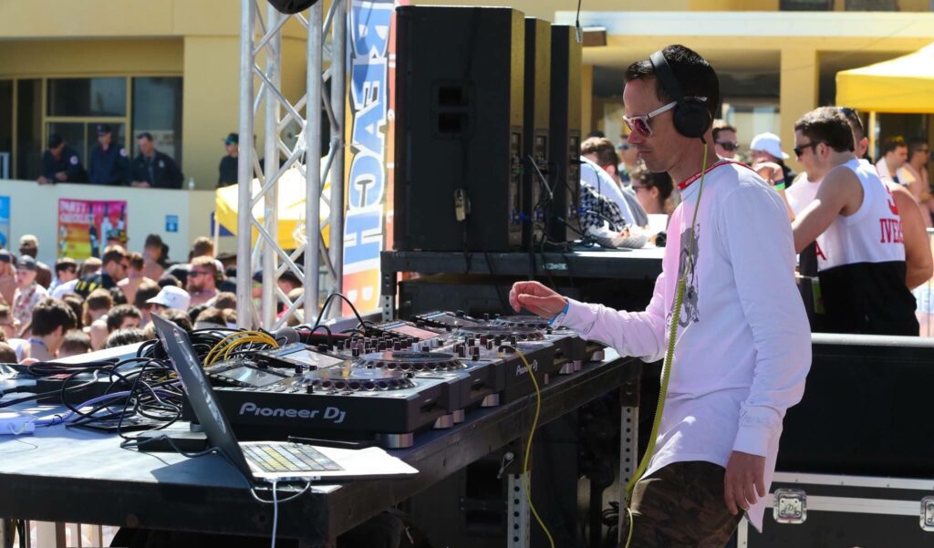 Josh Lawrence DJing at Beach Bash, opening for Borgore at a live event.